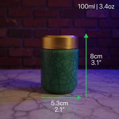 Deep Green Celadon Porcelain Stash Jar – Large & Small SizesGreen celadon porcelain stash jar with gold lid on a cracked surface