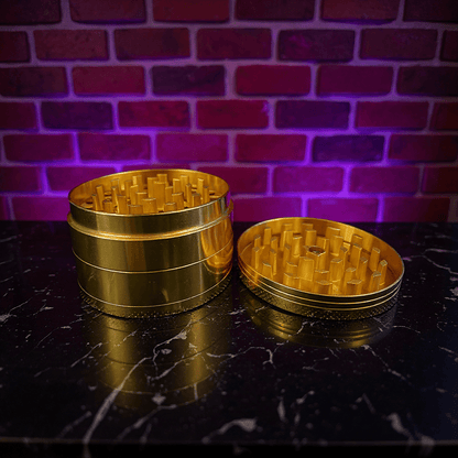 Doge Meme Herb Grinder - Gold metal grinder on a dark surface with a brick wall background