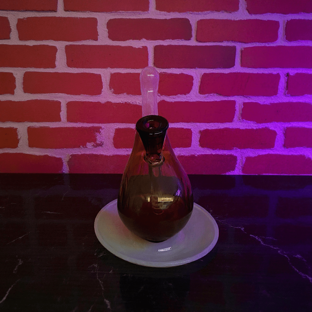 Drumstick Glass Bong – Mini Turkey Leg Water Pipe - Drumstick glass bong on a white plate with a brick wall background