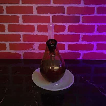 Drumstick Glass Bong – Mini Turkey Leg Water Pipe - Drumstick glass bong on a white plate with a brick wall background