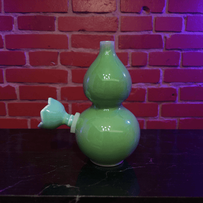 Glossy Green Celadon Gourd Porcelain BongGlossy Green Celadon Gourd Porcelain Bong with ceramic bowl is placed on a marble surface.