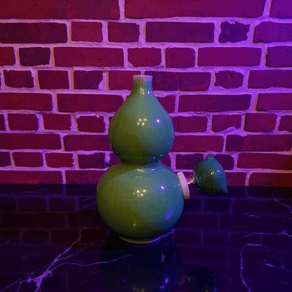 Glossy Green Celadon Gourd Porcelain BongGlossy Green Celadon Gourd Porcelain Bong with glass bowl is placed on a marble surface.