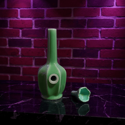 Glossy Green Flat - Sided Celadon Porcelain BongGlossy Green Flat - Sided Celadon Porcelain Bong and ceramic bowl are placed on a marble surface.