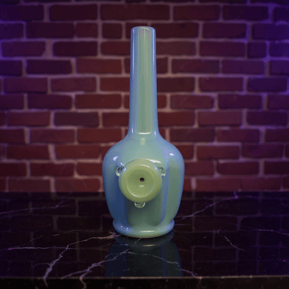 Glossy Light Blue Celadon Flat - Sided Porcelain BongGlossy Light Blue Celadon Flat - Sided Porcelain Bong with glass bowl is placed on a marble surface.