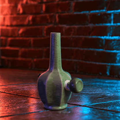 Green Dragon Scale Celadon Flat-Sided Porcelain BongIce - Crack Green Celadon Flat - Sided Porcelain Bong with glass bowl is placed on a wooden surface.