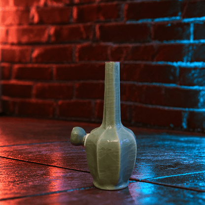 Green Dragon Scale Celadon Flat-Sided Porcelain BongIce - Crack Green Celadon Flat - Sided Porcelain Bong with glass bowl is placed on a wooden surface.