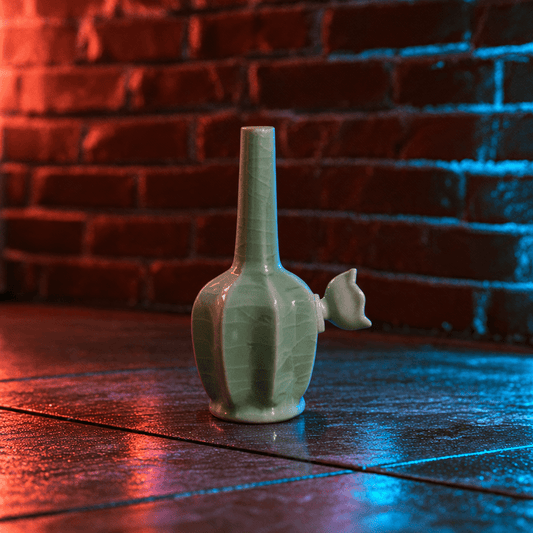 Green Dragon Scale Celadon Flat-Sided Porcelain BongIce - Crack Green Celadon Flat - Sided Porcelain Bong with ceramic bowl is placed on a wooden surface.