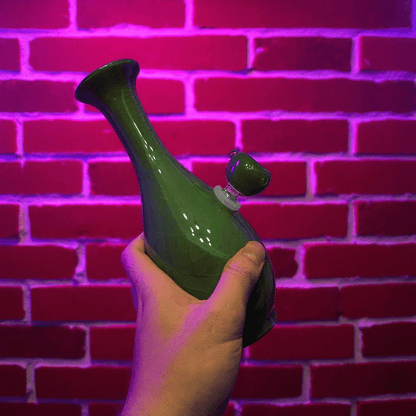 Green Ice - Crack Celadon Porcelain Bong with Flared TopGreen porcelain bong with glass bowl held in front of a red brick wall