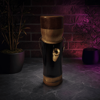 Handcrafted Bamboo Bong – Eco - Friendly Water Pipe with Natural AromaDecorative bamboo bong on a dark surface with a brick wall background.