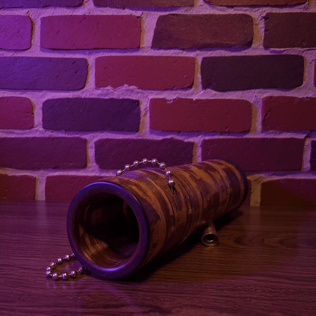 Handcrafted Bamboo Bong – Eco - Friendly Water Pipe with Natural Aromabamboo bong with metallic rings on a wooden surface