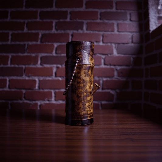 Handcrafted Bamboo Bong – Eco - Friendly Water Pipe with Natural Aromaa bamboo bong with decorative elements on a wooden surface
