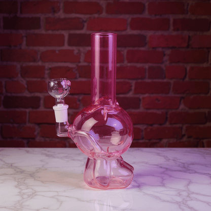 Hello Glow Mini Bong – Cute Style with Crystal Glass. Pink glass smoking bong on a marble surface