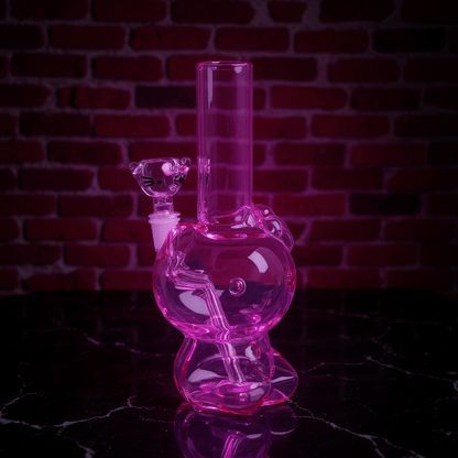 Hello Glow Mini Bong – Cute Style with Crystal GlassPink hello kitty glass bong with a brick wall background