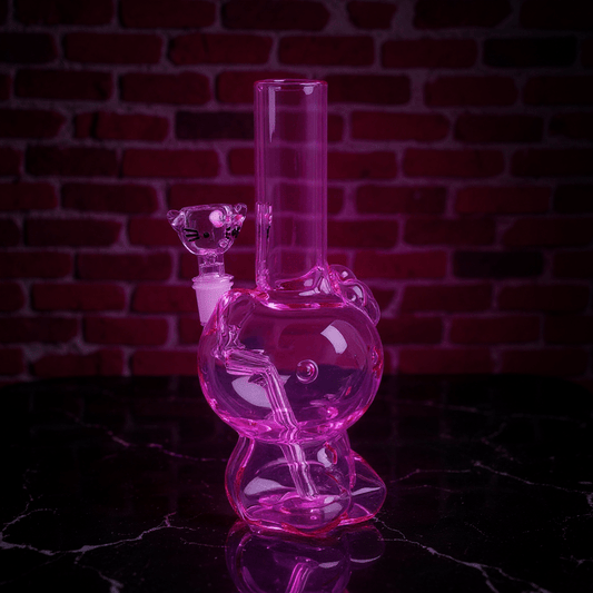 Hello Glow Mini Bong – Cute Style with Crystal GlassPink hello kitty glass bong with a brick wall background