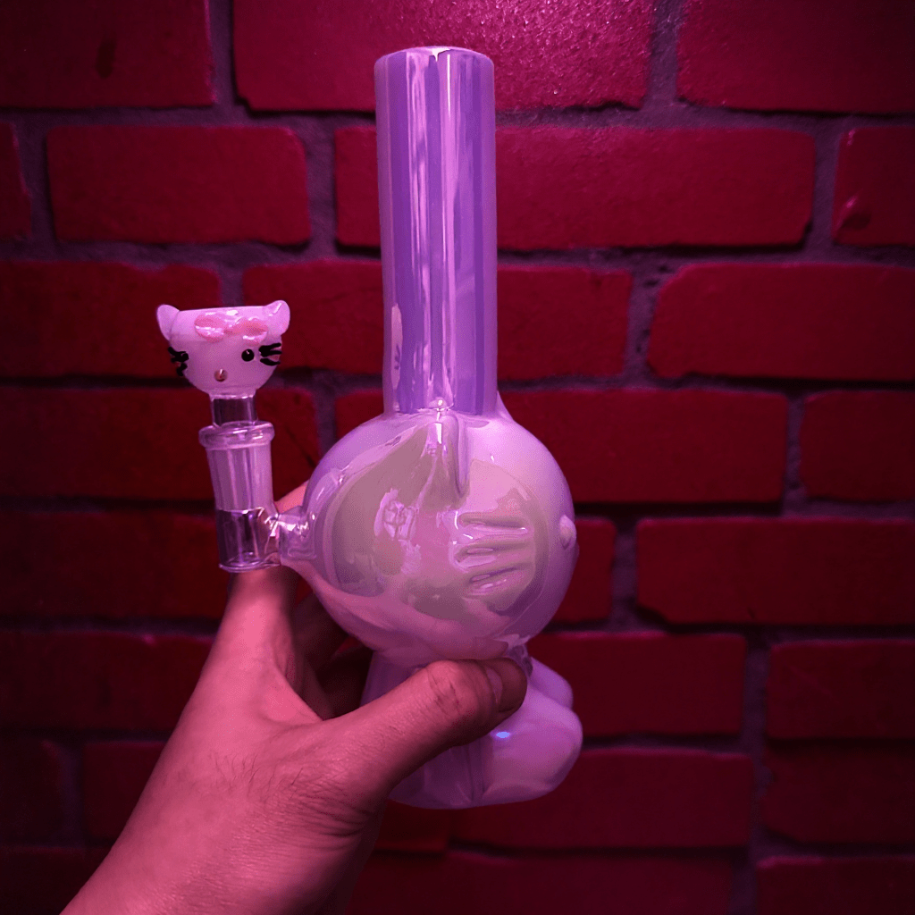 Hello Glow Mini Bong – Cute Style with Crystal Glass. Hello Glow Water Pipe. Hand holding a cute white Hello Kitty glass bong