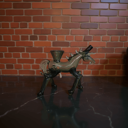 Horse Glass Hand Pipe - Decorative house glass hand pipe against a brick wall.