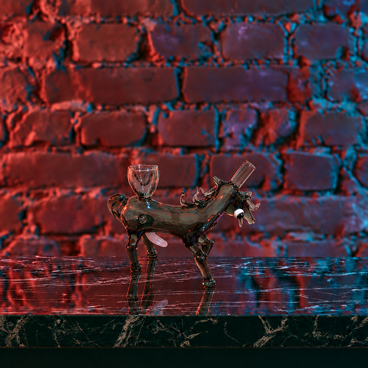 A bamboo water pipe with black burned-in patterns and a brass mouthpiece, standing on a dark marble surface against a dark brick wall with pink neon lighting and plants.