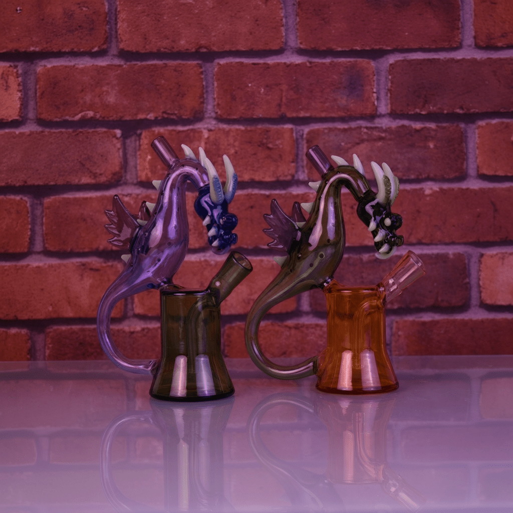 House of Dragon Glass Bong – RPG & Anime Style Water PipeTwo dragon glass with dragon designs against a brick wall background