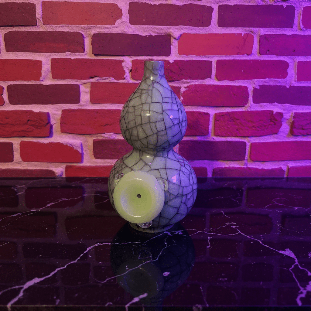 Ice - Crack Blue Celadon Gourd Porcelain BongDecorative ceramic bong with cracked pattern on a reflective surface