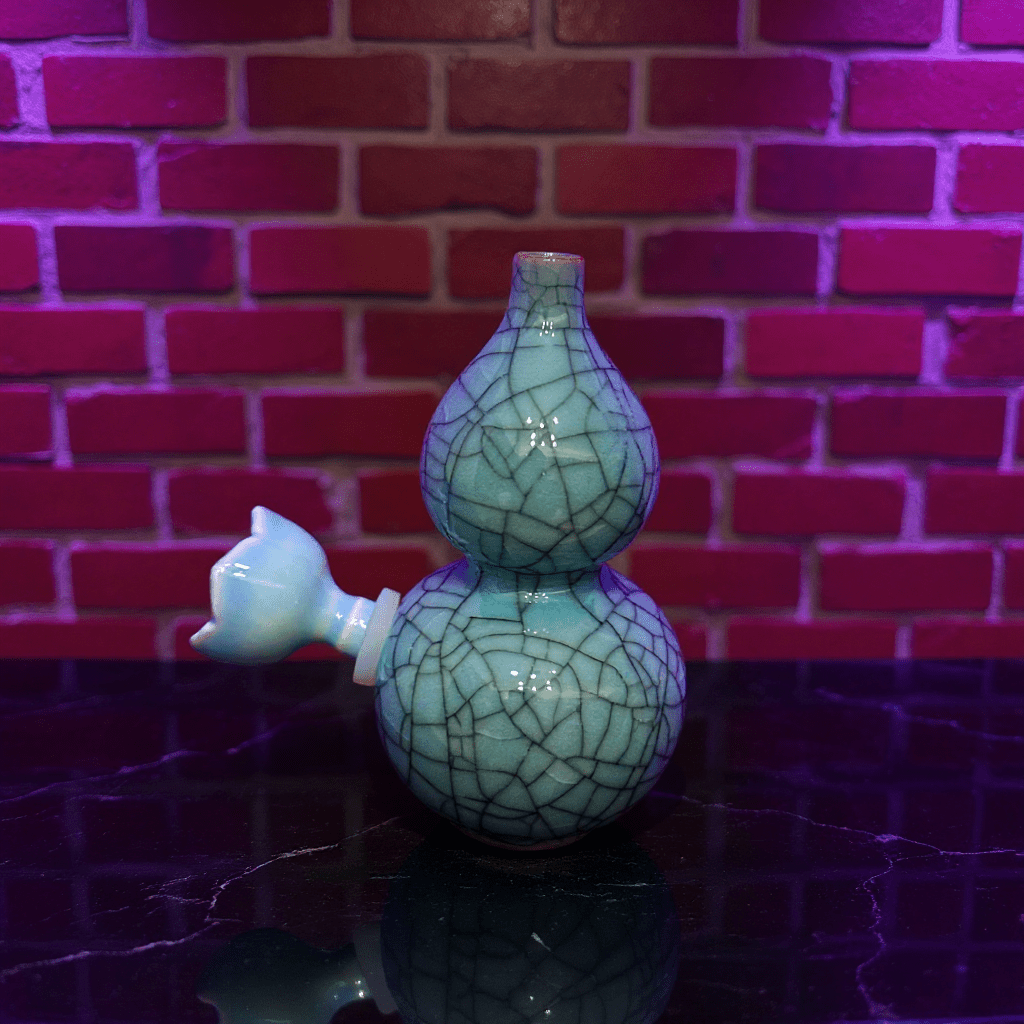 Ice - Crack Blue Celadon Gourd Porcelain BongIce - Crack Blue Celadon Gourd Porcelain Bong with ceramic bowl is placed on a marble surface.