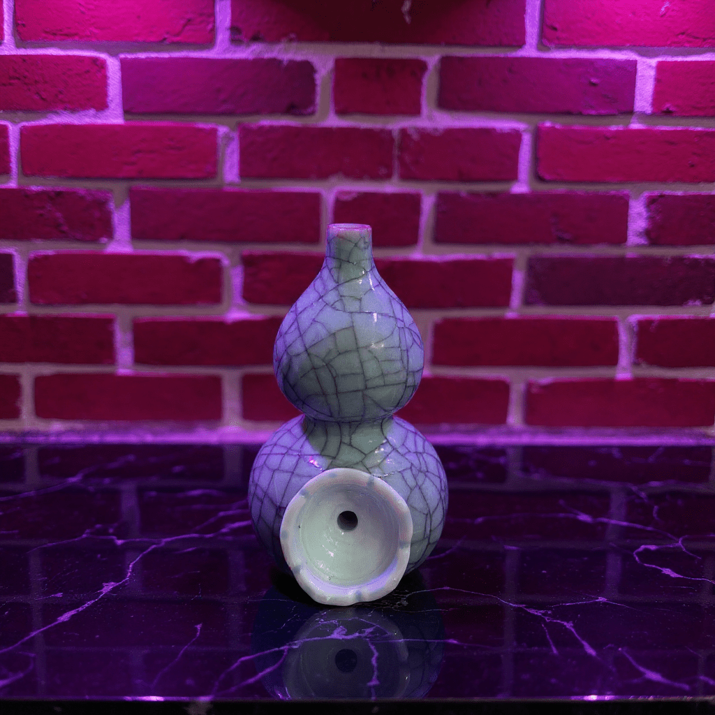 Ice - Crack Blue Celadon Gourd Porcelain BongGreen ceramic bong with textured surface on a reflective surface