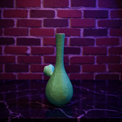 Ice - Crack Celadon Bong with Slim Neck DesignGreen textured ceramic bong on a dark surface with a brick wall background