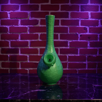 Ice - Crack Celadon Bong with Slim Neck Designslim neck ice - crack celadon ceramic bong with glass bowl is placed on a marble surface.