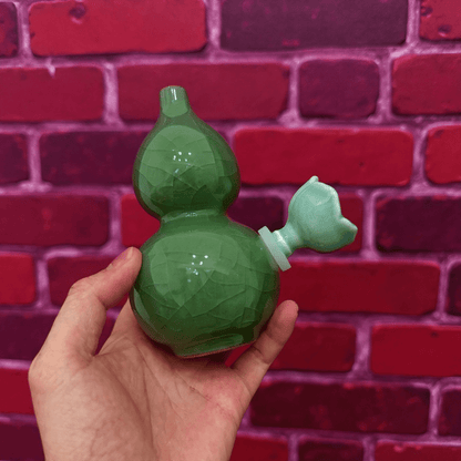 Ice - Crack Green Celadon Gourd Porcelain BongGreen porcelain bong with ceramic bowl held by hand in front of a red brick wall