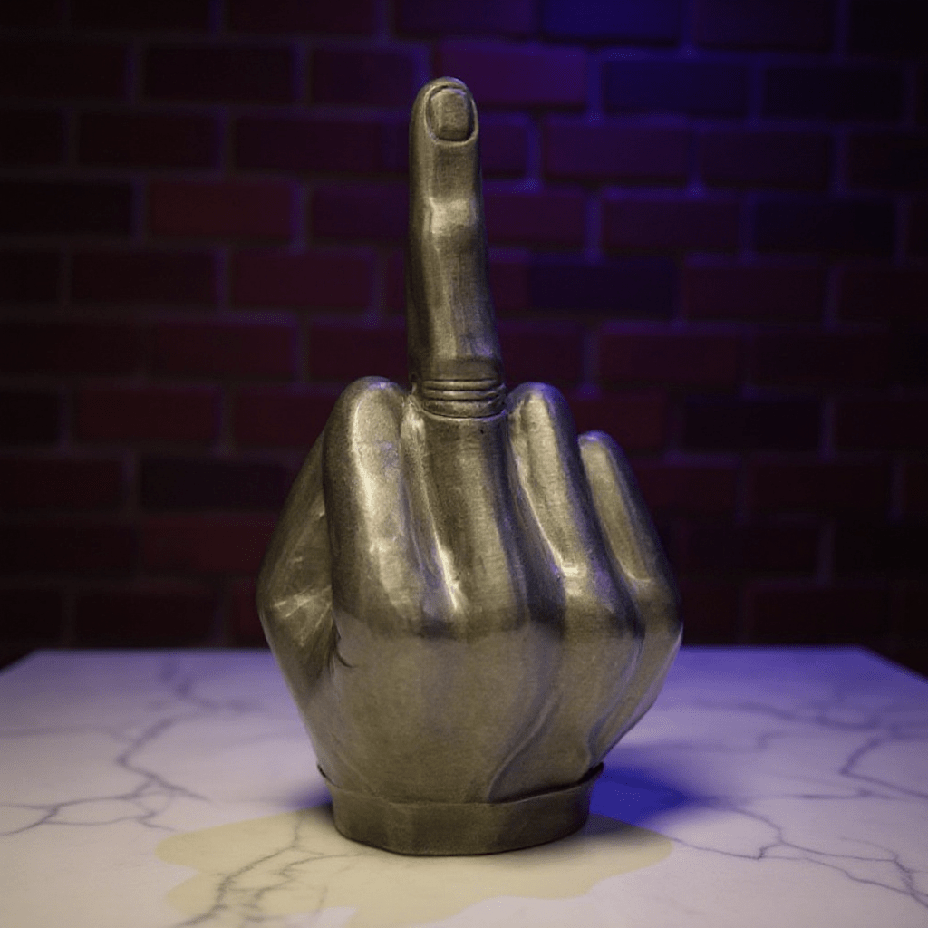 Middle Finger Grinder & Pipe Combo – Heavy Duty 2 - in - 1 SystemMetallic hand grinder with middle finger pointing upwards against a brick wall.