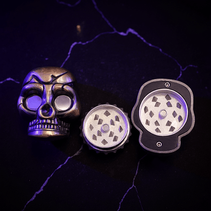 Mini Skull Herb Grinder – Vintage Bronze - Skull shaped grinder set on a dark background