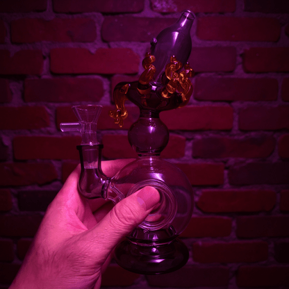 Mythical Creature Glass Bong – Fantasy StyleOctopus glass smoking bong held by a hand against a brick wall background