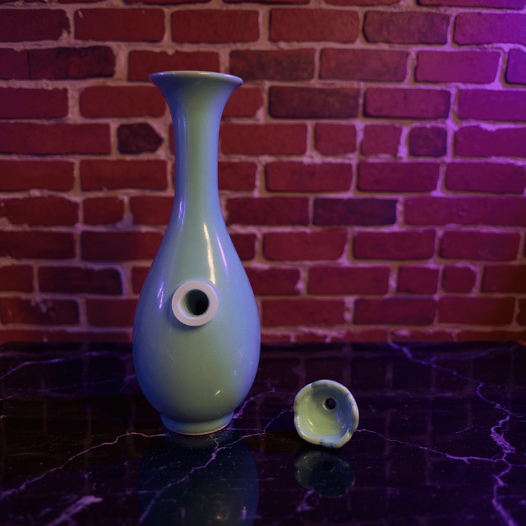 Pale Blue Flared Top Celadon Porcelain BongPale Blue Flared Top Celadon Porcelain Bong and ceramic bowl are placed on a marble surface