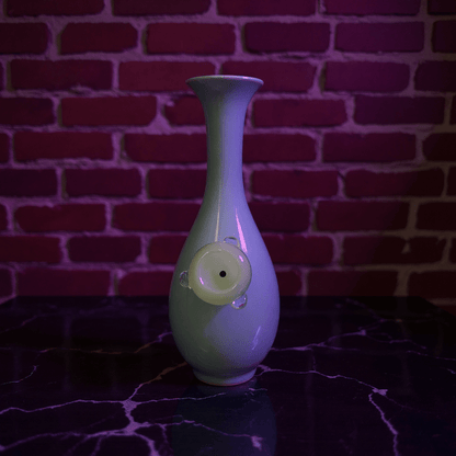 Pale Blue Flared Top Celadon Porcelain BongGreen ceramic bong with a unique design glass bowl on a dark surface