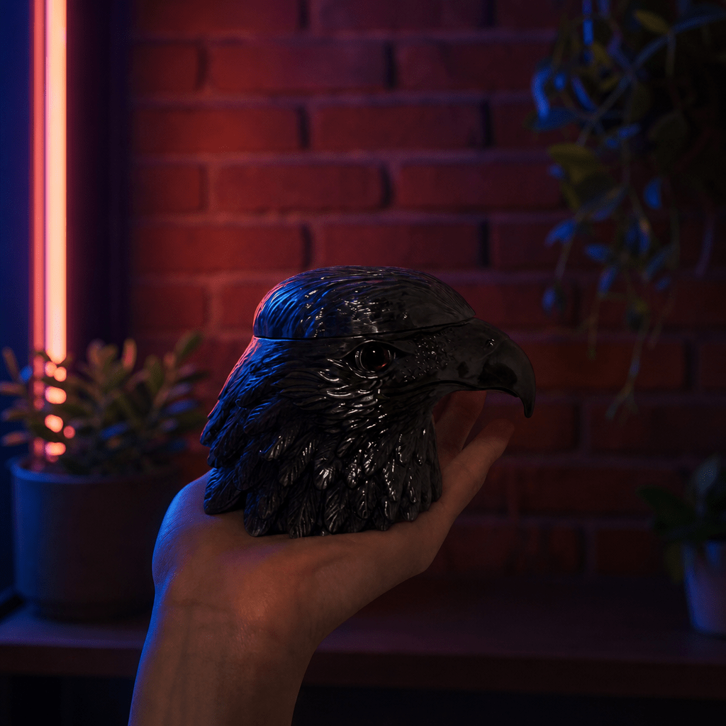 Patriot Eagle Head Metal Grinder – Brass, Bronze & Black FinishHand holding a bird - shaped grinder with a brick wall and neon light in the background