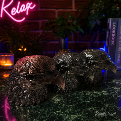 Decorative eagle grinder on a dark surface with a neon sign in the background