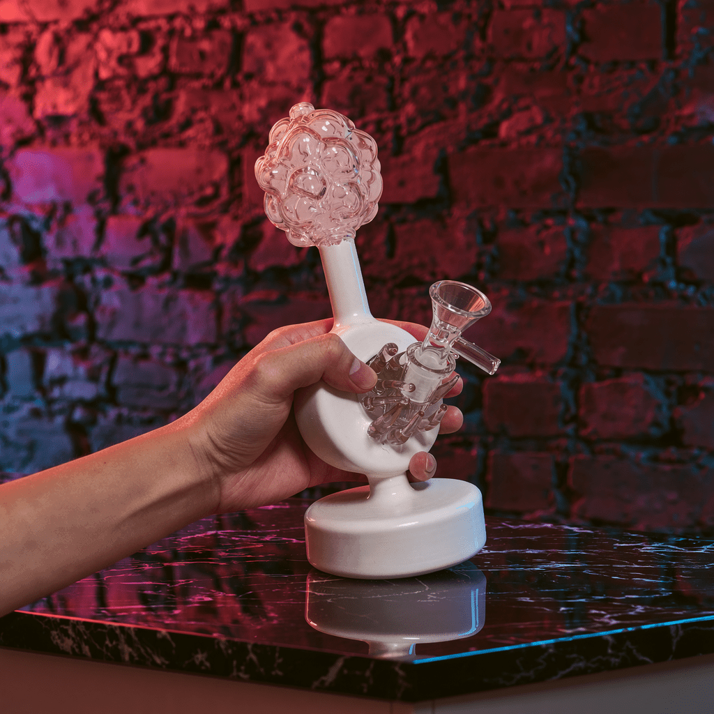 Plumbus-Inspired Sculptural BongA playful Plumbus-inspired bong with a surreal pink and cream sculptural design. A unique sci-fi water pipe made to stand out in any collection.