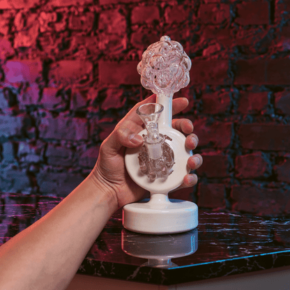Plumbus-Inspired Sculptural BongA playful Plumbus-inspired bong with a surreal pink and cream sculptural design. A unique sci-fi water pipe made to stand out in any collection.