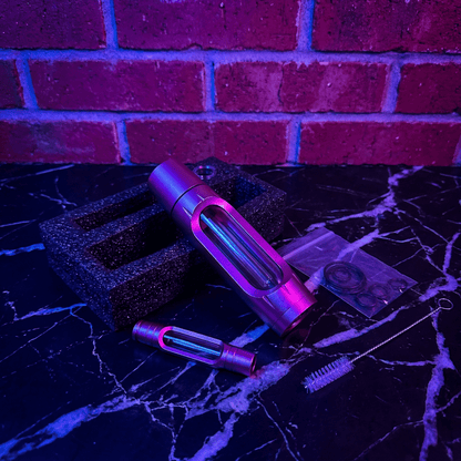 Heavy Duty Spill - Proof Water PipePurple UV light bong on a black surface with a brick wall background