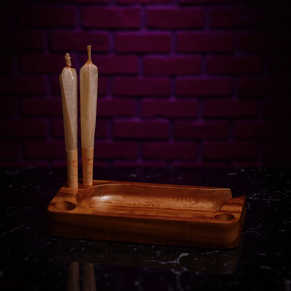 Premium Wooden Rolling Tray - Preset Tool for SmokingPremium Wooden Rolling Tray - Wooden tray holder with two joints against a dark brick wall.