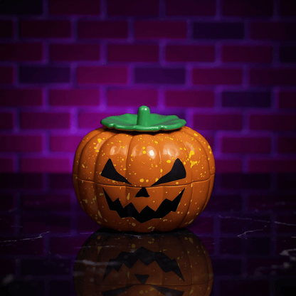 Pumpkin Herb Grinder – 3 - Piece GrinderPumpkin - shaped herb grinder with a green lid on a reflective surface