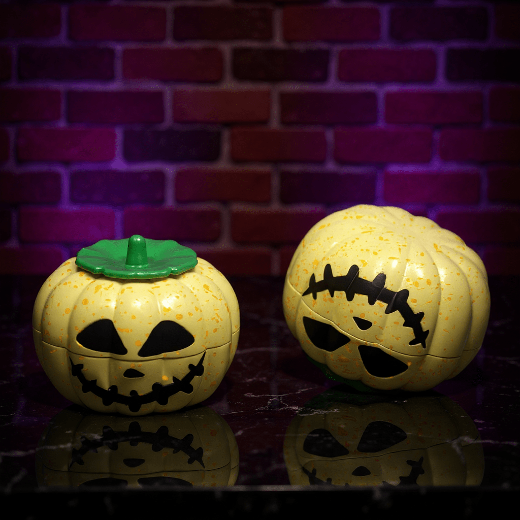 Pumpkin Herb Grinder – 3 - Piece GrinderTwo Halloween - themed herb grinders with jack - o' - lantern designs