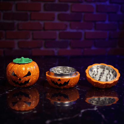 Pumpkin Herb Grinder – 3 - Piece GrinderHalloween - themed grinder with jack - o' - lantern design on a reflective surface