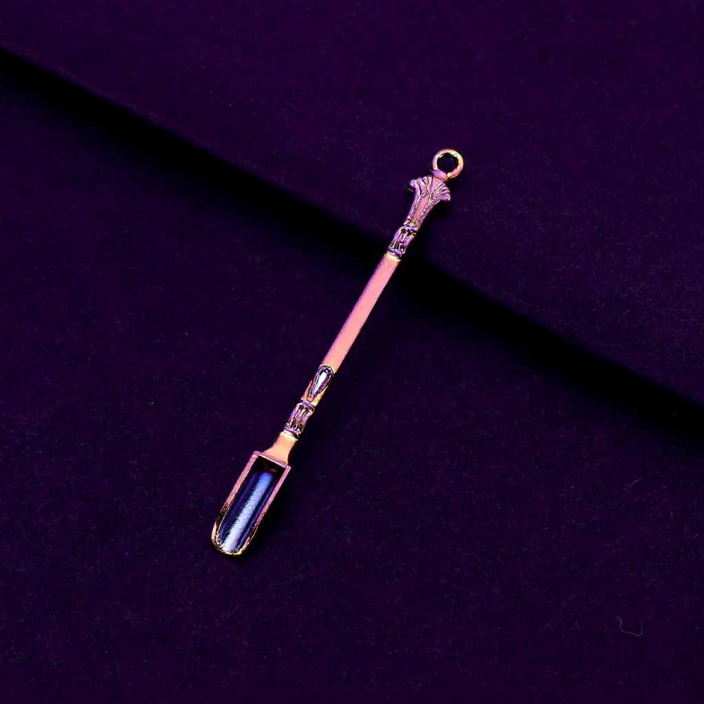 Rainbow Titanium Snuff Spoon – Mini Herb Scoop with LoopDecorative spoon with ornate handle on a dark purple background