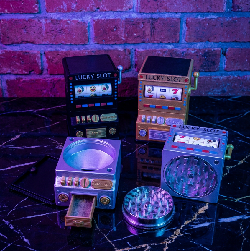 777 Jackpot Casino Novelty CrusherSet of colorful 'Lucky Slot' themed grinders against a brick wall background.