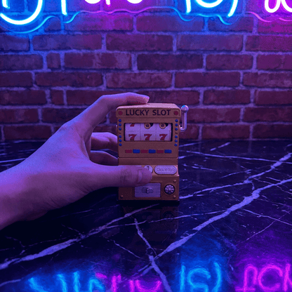 777 Jackpot Casino Novelty CrusherHand holding a small Lucky Slot grinder with neon lights in the background