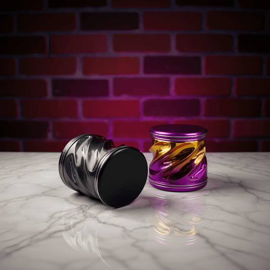 Spiral Grip Aluminum Herb Grinder - Two metallic herb grinders with swirling patterns on a marble surface