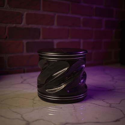 Spiral Grip Aluminum Herb Grinder - Metallic cylindrical tobacco grinder with a swirling design on a reflective surface
