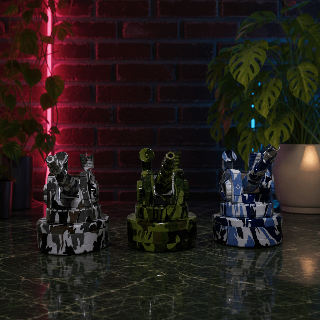 Tactical Operator Cannon Grinder & Pipe ComboThree grinder on a reflective surface with a brick wall and plants in the background.