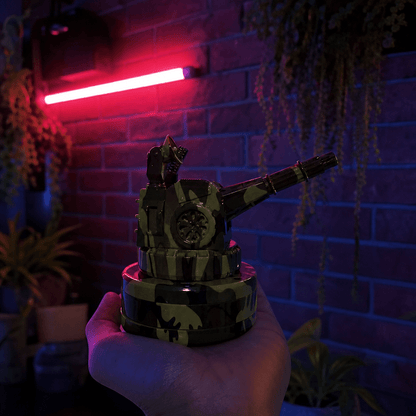 Tactical Operator Cannon Grinder & Pipe ComboHand holding a camouflaged tank grinder against a brick wall with neon lighting