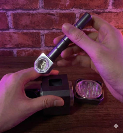 Thor Hammer Shape Grinder – 4 - Part Metal GrinderHand holding a smoking pipe and grinder against a brick wall background